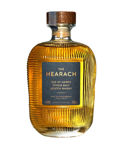 A bottle of The Hearach Isle of Harris Single Malt Scotch Whisky by The Hearach, featuring a ribbed glass design and a blue and copper label.