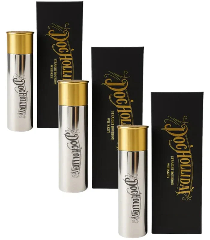 Three Doc Holliday 10 Year Bourbon Shotgun Shell Limited Edition 100mL silver and gold cylindrical bottles stand beside matching black rectangular boxes, both featuring the Doc Holliday name in gold script and arranged in pairs.