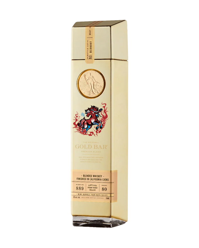 A tall, gold-colored bottle of Gold Bar Whiskey Year of the Horse 2026 Limited Edition features a raised gold coin, a decorative horse illustration, and a label noting it is American blended whiskey finished in California casks.
