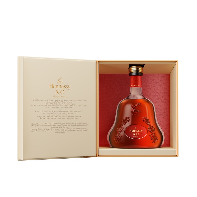 The Hennessy X.O Lunar New Year 2026 Limited Edition by Xu Zhen is displayed in an elegant open gift box with gold and red accents, embossed details, and printed text on the inside cover.