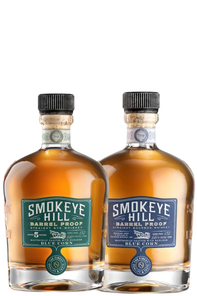The Smokeye Hill Barrel Proof Bundle: Straight Rye & Bourbon Whiskey features two round bottles with dark caps and green and blue labels, filled with amber liquid, standing side by side against a white background.