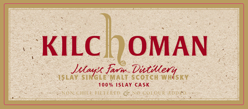 A beige Kilchoman label with red and gold text reads: Kilchoman 10 Year Old 100% Islay Cask Bourbon Single Cask Scotch Whisky, Islay’s Farm Distillery, Non-Chill Filtered & No Colour Added.